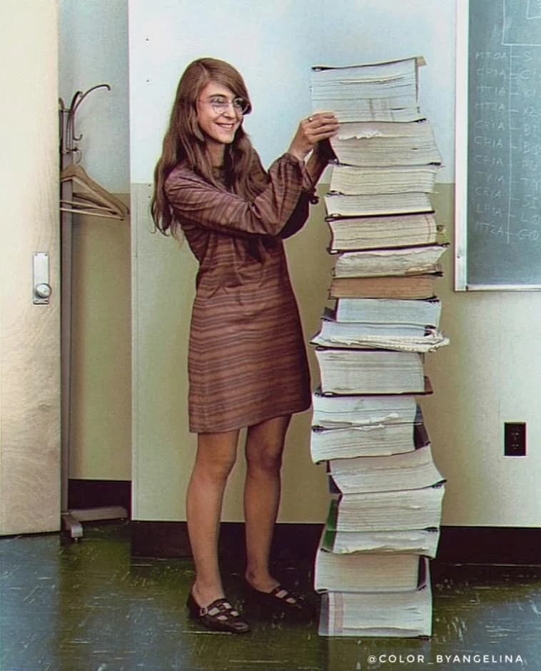 Margaret Hamilton standing next to the Apollo Guidance Computer source code listings, MIT, 1969